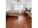 The bedroom features hardwood floors, natural light from curtained windows, and ceiling fan at 3260 Henderson Mill Rd # A, Atlanta, GA 30341