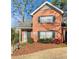 Charming brick home featuring a well-maintained lawn and manicured shrubbery at 3260 Henderson Mill Rd # A, Atlanta, GA 30341