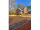 Charming brick townhouse with meticulously landscaped front yard, sidewalk and blue sky at 3260 Henderson Mill Rd # A, Atlanta, GA 30341