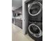 Kitchen view features stacked washer and dryer and stainless steel appliances and gray cabinets at 3260 Henderson Mill Rd # A, Atlanta, GA 30341