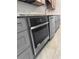 Stainless steel oven and dishwasher complement the gray cabinetry and gray countertops at 3260 Henderson Mill Rd # A, Atlanta, GA 30341