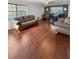 Spacious living room featuring hardwood floors, large windows, and stylish furniture at 3260 Henderson Mill Rd # A, Atlanta, GA 30341