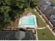 An aerial view of the community pool area surrounded by lush trees and well-maintained lawns at 3260 Henderson Mill Rd # A, Atlanta, GA 30341
