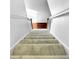 Carpeted staircase ascends to the next level with white walls and trim providing a bright and clean transition between floors at 3260 Henderson Mill Rd # A, Atlanta, GA 30341