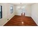Open dining room featuring hardwood floors and a modern chandelier at 180 Antebellum Way, Fayetteville, GA 30215