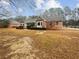Charming brick home featuring mature trees, a well-maintained lawn, and lovely curb appeal in a quiet neighborhood at 180 Antebellum Way, Fayetteville, GA 30215