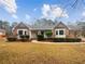 Charming brick home with well-manicured landscaping and inviting front porch at 180 Antebellum Way, Fayetteville, GA 30215
