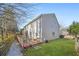 Backyard view with a wooden deck featuring outdoor seating and a grill, leading to a well-maintained lawn at 854 Malvern Blvd, Stone Mountain, GA 30087
