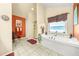 Large bathroom with a soaking tub, separate shower, and plenty of counter space at 854 Malvern Blvd, Stone Mountain, GA 30087