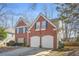 Side view of a brick home with a two-car garage and some landscaping at 854 Malvern Blvd, Stone Mountain, GA 30087
