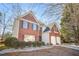 Brick home with a manicured landscape and a driveway leading to a two-car garage at 854 Malvern Blvd, Stone Mountain, GA 30087