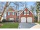 Charming two-story brick home with a well-manicured lawn and a two-car garage at 854 Malvern Blvd, Stone Mountain, GA 30087