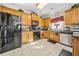 Well-lit kitchen features tile flooring, stainless steel appliances, and plenty of wooden cabinetry at 854 Malvern Blvd, Stone Mountain, GA 30087