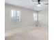 This bedroom features neutral walls and carpet, two windows, and a ceiling fan at 1160 Windsor Pkwy # 13, Atlanta, GA 30319