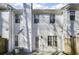 Back exterior featuring the patio, white siding, chimney, and windows with shutters at 1160 Windsor Pkwy # 13, Atlanta, GA 30319