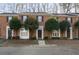 Charming brick townhome featuring black shutters and a well-maintained front yard with mature trees at 1160 Windsor Pkwy # 13, Atlanta, GA 30319