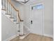 Inviting foyer showcasing the staircase with carpeted steps and a white front door for a classic look at 1160 Windsor Pkwy # 13, Atlanta, GA 30319
