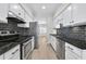 Eat-in kitchen features stainless steel appliances, white cabinetry, wood floors, and granite countertops at 1160 Windsor Pkwy # 13, Atlanta, GA 30319