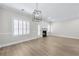 Bright living room featuring wood floors, a fireplace, and a modern light fixture at 1160 Windsor Pkwy # 13, Atlanta, GA 30319