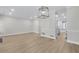 Spacious living room featuring wood floors, a modern light fixture, and neutral walls at 1160 Windsor Pkwy # 13, Atlanta, GA 30319