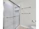 An updated tiled shower with a glass door and built-in shelves at 1160 Windsor Pkwy # 13, Atlanta, GA 30319