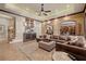 Cozy living room featuring a large leather sectional, stone accent wall, and wood trim at 3030 Creek Tree Ln, Cumming, GA 30041