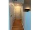 Hallway featuring white doors and wood floors throughout the unit at 361 17Th Nw St # 2308, Atlanta, GA 30363