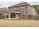 Spacious backyard with a covered patio offering an inviting outdoor living space and a fenced perimeter at 600 Lockerbie Ter, Mcdonough, GA 30252