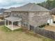 A well-maintained backyard with a covered patio perfect for outdoor relaxation and entertaining with a fenced perimeter at 600 Lockerbie Ter, Mcdonough, GA 30252
