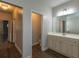 Bathroom featuring vinyl floors, neutral walls, and a double vanity with ample storage space at 600 Lockerbie Ter, Mcdonough, GA 30252