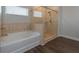 Modern bathroom featuring separate tub and shower with glass door and tile surround at 600 Lockerbie Ter, Mcdonough, GA 30252