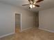Neutral bedroom features a ceiling fan and a walk-in closet for ample storage space at 600 Lockerbie Ter, Mcdonough, GA 30252