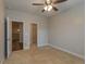 Bedroom featuring neutral walls, carpet flooring, a ceiling fan, and access to a walk-in closet at 600 Lockerbie Ter, Mcdonough, GA 30252