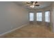 Bedroom with carpet, three windows, and decorative curtains at 600 Lockerbie Ter, Mcdonough, GA 30252