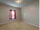 Bedroom featuring neutral walls, carpet flooring, one window and modern lighting at 600 Lockerbie Ter, Mcdonough, GA 30252