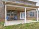 Covered patio featuring a seating area with a small table and two chairs at 600 Lockerbie Ter, Mcdonough, GA 30252