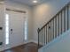 Bright entryway features hardwood floors, white door and black wrought iron staircase at 600 Lockerbie Ter, Mcdonough, GA 30252