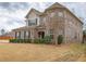 Beautiful two-story brick home featuring a turret, manicured bushes, and a well-kept lawn at 600 Lockerbie Ter, Mcdonough, GA 30252