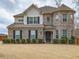 Beautiful two-story brick home featuring a turret, manicured bushes, and a well-kept lawn at 600 Lockerbie Ter, Mcdonough, GA 30252