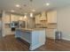 Bright kitchen boasts stainless appliances, kitchen island and granite countertops at 600 Lockerbie Ter, Mcdonough, GA 30252