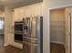 Kitchen features stainless appliances, granite counters, and walk-in pantry at 600 Lockerbie Ter, Mcdonough, GA 30252