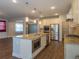 Bright kitchen boasts stainless appliances, kitchen island and granite countertops at 600 Lockerbie Ter, Mcdonough, GA 30252