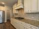 Kitchen features stainless appliances, granite counters, tile backsplash and range at 600 Lockerbie Ter, Mcdonough, GA 30252