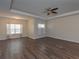 Spacious living room with modern tray ceilings, ceiling fan and abundant natural light at 600 Lockerbie Ter, Mcdonough, GA 30252