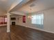 Open living room with hardwood floors, fireplace, tv, and chandelier at 600 Lockerbie Ter, Mcdonough, GA 30252