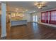 Open-concept living room boasts hardwood floors, ceiling fan, kitchen bar and natural light at 600 Lockerbie Ter, Mcdonough, GA 30252
