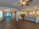 Open-concept living room featuring hardwood floors, view to kitchen and staircase at 600 Lockerbie Ter, Mcdonough, GA 30252