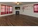 Spacious living room featuring hardwood floors, fireplace, TV, and decorative wall art at 600 Lockerbie Ter, Mcdonough, GA 30252