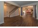 Spacious living room with hardwood flooring, gray curtains, staircase, and chandelier at 600 Lockerbie Ter, Mcdonough, GA 30252