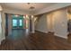 Living room featuring hardwood floors, chandelier, and gray curtains at 600 Lockerbie Ter, Mcdonough, GA 30252